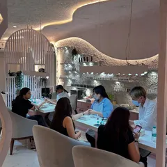 A look at our manicure stations, where clients relax in comfortable chairs while our technicians work their magic. The design focuses on creating a serene and aesthetic experience.