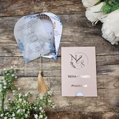 This unique fan-shaped invitation is both playful and elegant. The set includes multiple acrylic "blades" that pivot open to reveal event details, all held together with a beautiful tassel and tucked into a custom monogrammed sleeve.