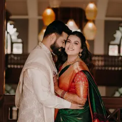 A stunning portrait of a couple during their engagement ceremony in Nashik. The rich colors of her saree and the elegant decor create a royal feel.