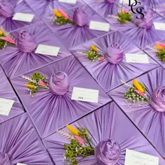 This beautiful lavender fabric-wrapped gift, accented with colourful dried flowers, showcases a softer, more romantic style of presentation. It’s perfect for personal milestones or as an elegant thank you gift.