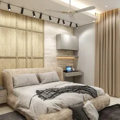Another angle of the multi-functional bedroom, showing the compact study or work-from-home nook next to the bed. The track lighting on the ceiling ensures the entire space is well-lit.