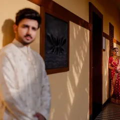 A creative shot using a hallway and dramatic lighting to frame the couple. This play of light and shadow adds a cinematic quality to the wedding photos.