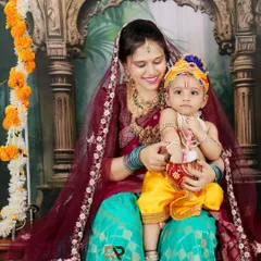 A beautiful mother and child portrait inspired by Radha and Krishna. The intricate costumes, traditional backdrop, and loving interaction make this a truly special themed shoot.