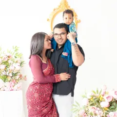 A beautiful family portrait showcasing their love and connection. The mother's traditional saree adds a touch of elegance to this timeless photo.