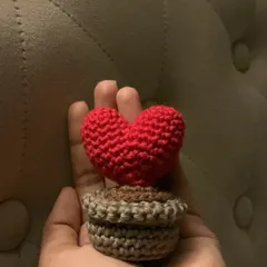 A love that never wilts! This is a small, puffy crochet heart "planted" in a tiny pot, made with lots of love. It's a perfect little piece of desk decor.