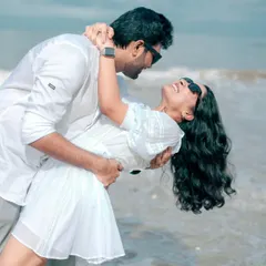 A fun and romantic dip in the ocean. This beach pre-wedding shot is full of energy and happiness, perfectly capturing the playful side of a couple's relationship.