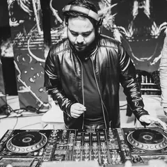 An artistic shot of me mixing at a gig. I am deeply involved in the technical side of DJing, ensuring every transition is smooth and every beat drop has maximum impact.