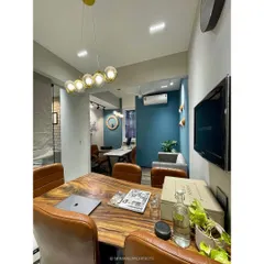A view of our conference room, with its live-edge wooden table and a bold blue accent wall. It's a professional yet inspiring environment for our client meetings and team discussions.