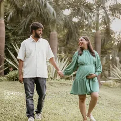 Walking hand in hand through a green park, this couple shares a smile. I love capturing these simple, moving moments that tell the story of their journey together.
