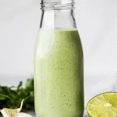 My Creamy Cilantro Lime dressing, bottled and ready. It's a fresh and zesty dressing made with cilantro, lime, and garlic, perfect for salads or as a dip.