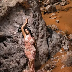A full-length view of the couture gown against the dramatic desert landscape. My direction here was to create a powerful, almost mythical image that feels both high-fashion and organic.
