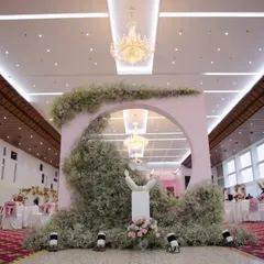 This unique photo booth was a highlight of the reception. A circular arch enveloped in delicate baby's breath provides a dreamy, cloud-like effect for beautiful guest portraits.
