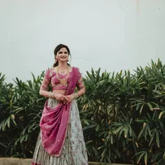 A full-length shot of the client in her Langa Dhawani, smiling happily. This shows the complete flow and grace of the outfit.