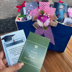 A closer look at the personalized cards for a graduation hamper. I design custom messages like "The Tassel Was Worth The Hassle" to add a special, congratulatory touch to the gift.