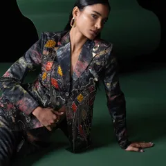 Another look from the Advait campaign, this time a full suit with intricate embellishments. The seated pose creates an elegant and grounded feel, contrasting with the vibrant energy of the other shots.