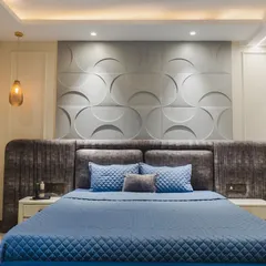 Your bedroom should be your personal sanctuary. For this master bedroom, I used a calming palette of blues and greys, a textured 3D panel behind the bed, and soft, indirect lighting to create a space that feels both spacious and deeply relaxing.