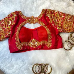I love bringing symbolic designs to life, like the bird motifs on this classic red bridal blouse. This piece showcases detailed zardosi and French knot embroidery, a testament to the handwork that goes into every creation.