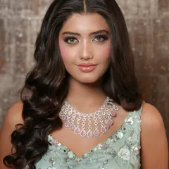 A close-up of the soft glam makeup. The focus is on radiant skin, subtly defined eyes, and glossy lips, creating a fresh and youthful look perfect for an evening event.