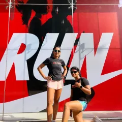 Posing with a fellow pacer in front of a Nike Run mural. We are here to support and guide you through every step of your run.