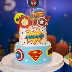 This two-tier superhero cake is a universe of excitement, featuring logos of Superman, Batman, The Flash, and Captain America. Our themed cakes are designed to be the centerpiece of your child's celebration.
