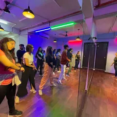 The full-length mirrors are a key asset during workshops, allowing a large group of dancers to learn and practice in unison while following the instructor.