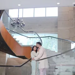 A romantic portrait on a grand staircase. This shot from their Roka ceremony uses the architecture to create a beautiful frame for the couple's intimate embrace.