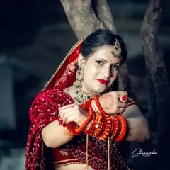 The vibrant red of a bridal lehenga stands out in this outdoor portrait. I focus on capturing the bride's confidence and grace, using lighting that makes the rich colors and intricate details of her wedding attire pop.