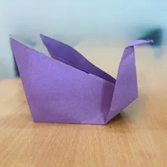 A close-up of a delicate paper swan crafted during our origami session. This activity is excellent for developing fine motor skills, patience, and the ability to follow instructions.