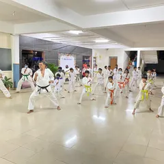 A Sensei leads the class in Kihon practice at the Silicon City dojo, demonstrating the correct form and ensuring every student develops a strong technical base.