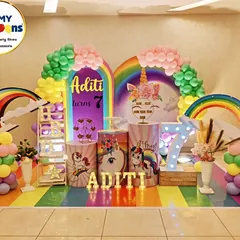 A magical unicorn and rainbow theme for Aditi's 7th birthday. We created a complete fantasy world with a rainbow-striped floor, multiple rainbow arches, unicorn-themed props, and a large light-up number '7', perfect for a whimsical celebration.