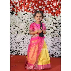 Another one of my little clients shining in a traditional half saree. The bright yellow and pink combination is perfect for festive celebrations, making her look like a little princess.