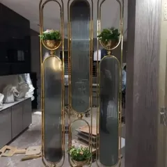 Another example of a custom metal and glass partition. This one incorporates built-in planters, blending functionality with biophilic design to bring a touch of nature indoors.