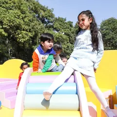The pastel rainbow roller slide is one of my most requested items. It helps toddlers learn to climb and balance in a safe, soft environment.