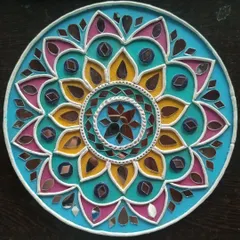 A finished Lippan art piece, showcasing the vibrant colors and intricate mirror work that make this traditional craft so special. In my workshop, you'll learn to create your own beautiful mandala-style design.