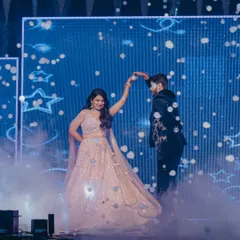 A fairytale first dance. I used a bubble machine and a dreamy blue LED backdrop with star motifs to create this magical moment, making the couple feel like they were dancing in the clouds.