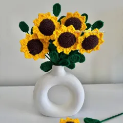 These are my handmade crochet sunflowers, which I call 'forever flowers' because they never wilt. This bouquet shows how bright and cheerful they are, perfect for adding a pop of color to your home without needing any water or sunlight. They make a lovely, lasting gift.