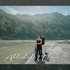 Standing strong together against the vastness of the river and mountains. This wide shot captures the epic scale of the landscape, making the couple's portrait feel both grand and timeless.