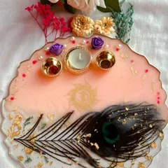 This tilak plate was created exactly to my client's wishes. It combines a soft pink base with a real peacock feather, gold leaf, and small purple roses for a unique and spiritual touch.