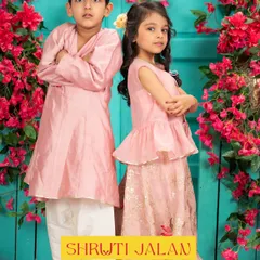 This brother-sister duo in soft pink is the definition of festive charm. The girl's peplum top lehenga perfectly complements her brother's simple, elegant angrakha-style kurta.