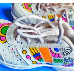 A close-up shot focusing on the laces and the detailed patterns along the side, showing how the design integrates with the shoe's structure.