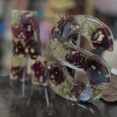 A set of 'M' and 'S' alphabet blocks made from deep red roses and pearls. These can be made into lamps or kept as decorative pieces.