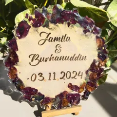 The preserved rose petal plaque displayed on a small easel. It's a wonderful way to display a memory from a special day.