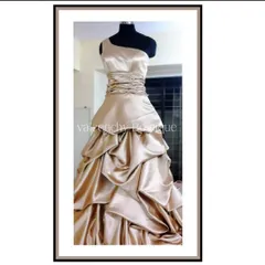 I crafted this elegant evening gown from shimmering champagne satin. The design features a contemporary one-shoulder neckline, a finely ruched bodice to ensure a perfect fit, and a dramatic tiered skirt with cascading drapes. This is the kind of custom formal wear I love to create for special occasions.