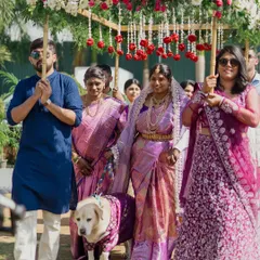 The grand entrance at a family milestone event. I capture the full procession, with the guest of honor walking under a beautiful floral canopy held by her family, creating a truly cinematic moment.