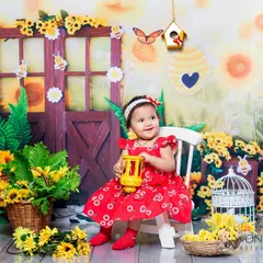 A bright and sunny sunflower and bee-themed portrait. The cheerful colors and cute props create a wonderful garden scene for this happy baby.
