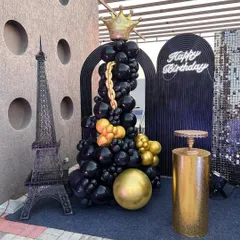 For a sophisticated adult birthday on a terrace, I designed this chic black and gold theme. The setup includes a statement balloon sculpture with a crown, a miniature Eiffel Tower for a touch of Parisian elegance, and a glowing neon sign, creating a perfect photo-op spot.
