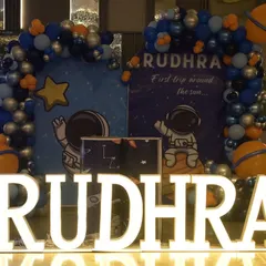 Rudhra's first trip around the sun was an out-of-this-world adventure. We designed a complete space theme with astronaut and planet cutouts, a galaxy-inspired balloon arch in shades of blue, silver, and orange, and large light-up letters, making it a stellar first birthday party.