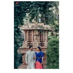 A beautiful portrait of a couple in traditional South Indian attire, framed by lush greenery with a stone chariot in the background. This shot feels like a scene from a classic romance.