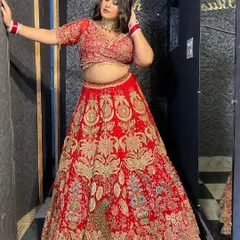 This stunning red bridal lehenga features detailed peacock embroidery and a rich, vibrant color, making it a showstopper for any bridal portfolio.