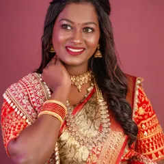 A close-up of the makeup, featuring a bold red lip and defined eyes that beautifully suit her complexion.